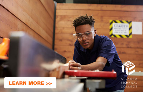 Young male wearing goggles while woodworking