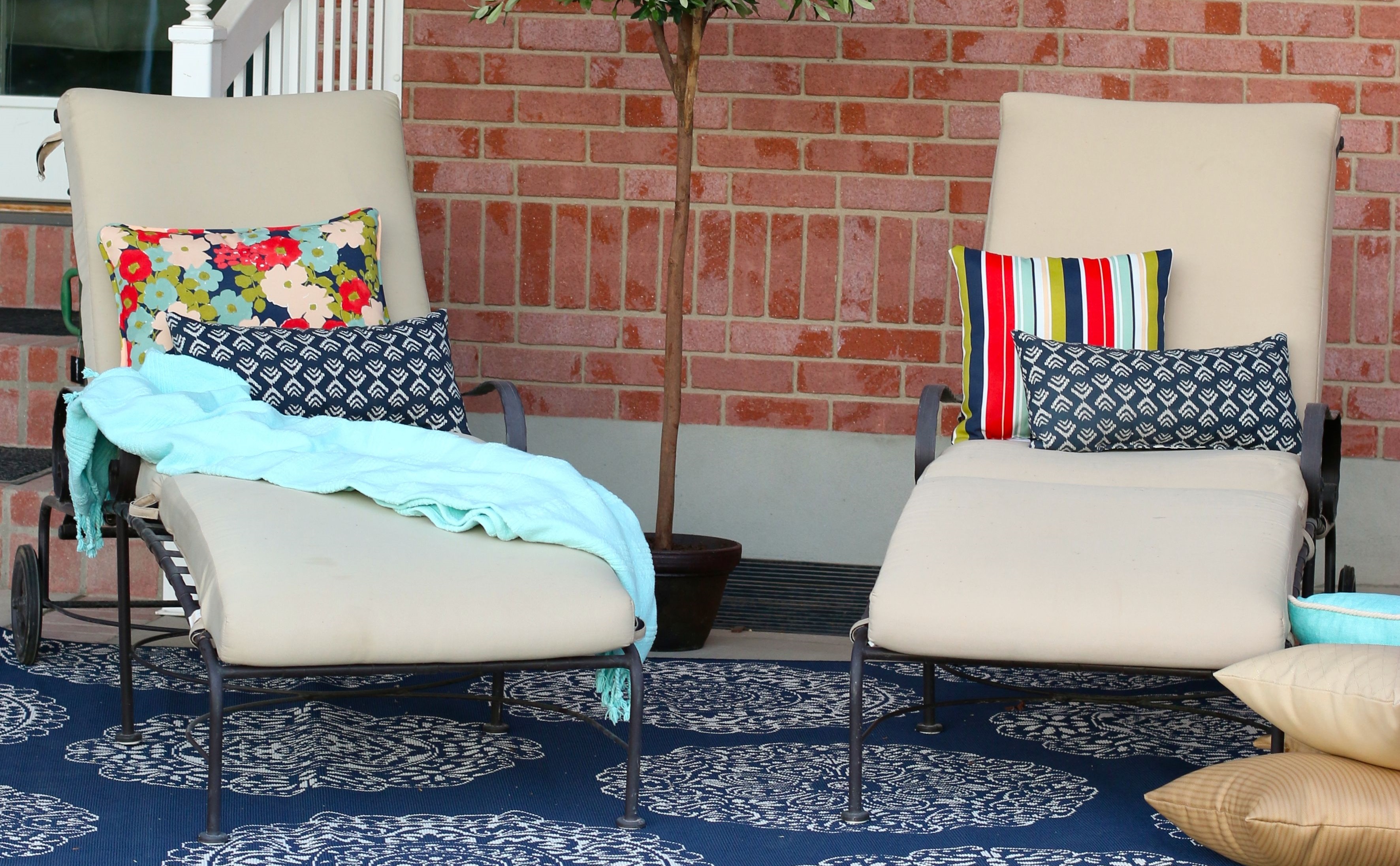 Patio set from The Home Depot featuring brightly colored pillows and textured rug