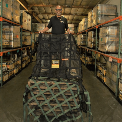 Supplier posing with cargo net in warehouse