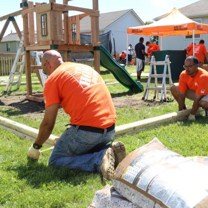Team Depot volunteers work on new playground for veteran family