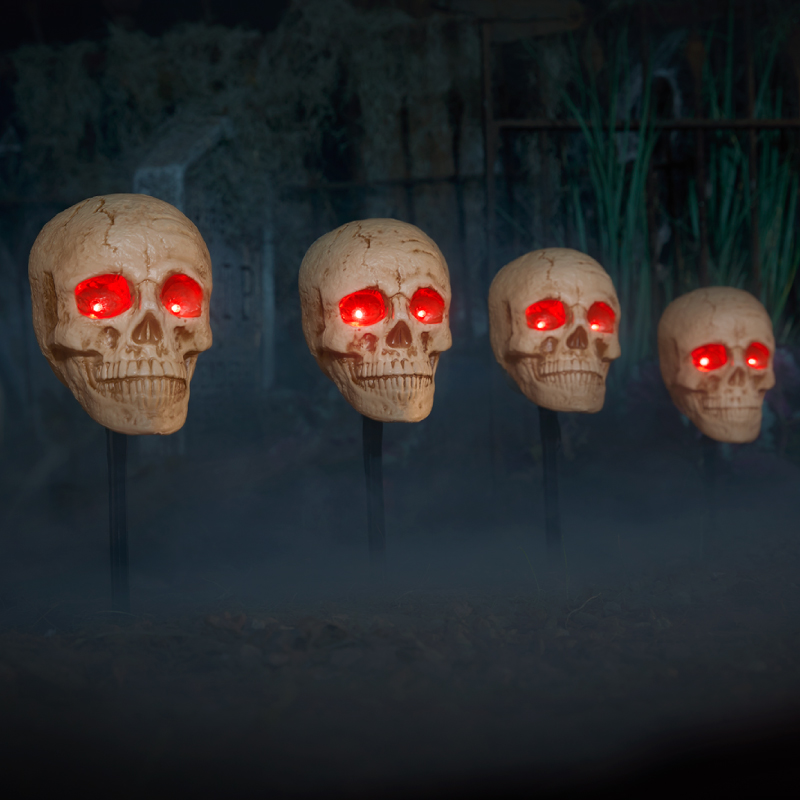 Skulls with red eyes on stakes 