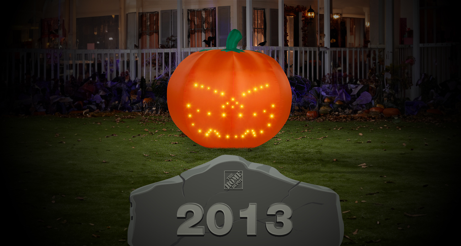 Inflatable pumpkin behind a 2013 tombstone