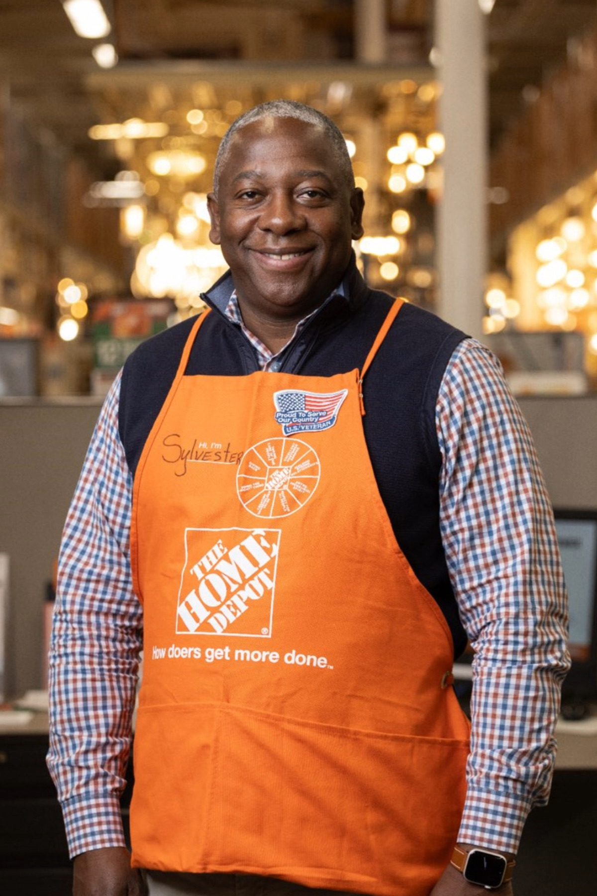 Sylvester Johnson in store wearing orange apron