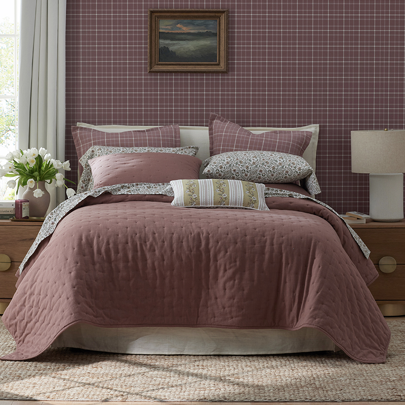 The company store’s collaboration with Stoffer Home bedding on top of a bed