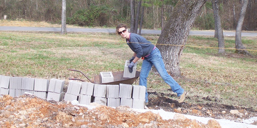 Cara Brookins moving concrete blocks