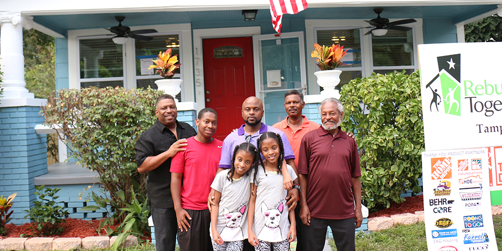 Cruse family outside newly repaired home