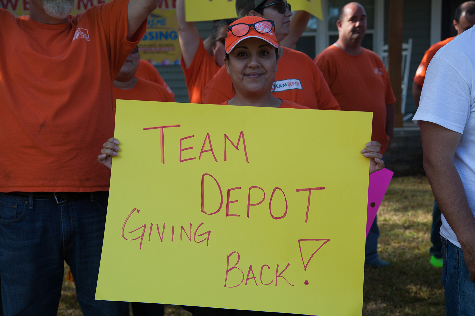 Team Depot volunteer holding sign