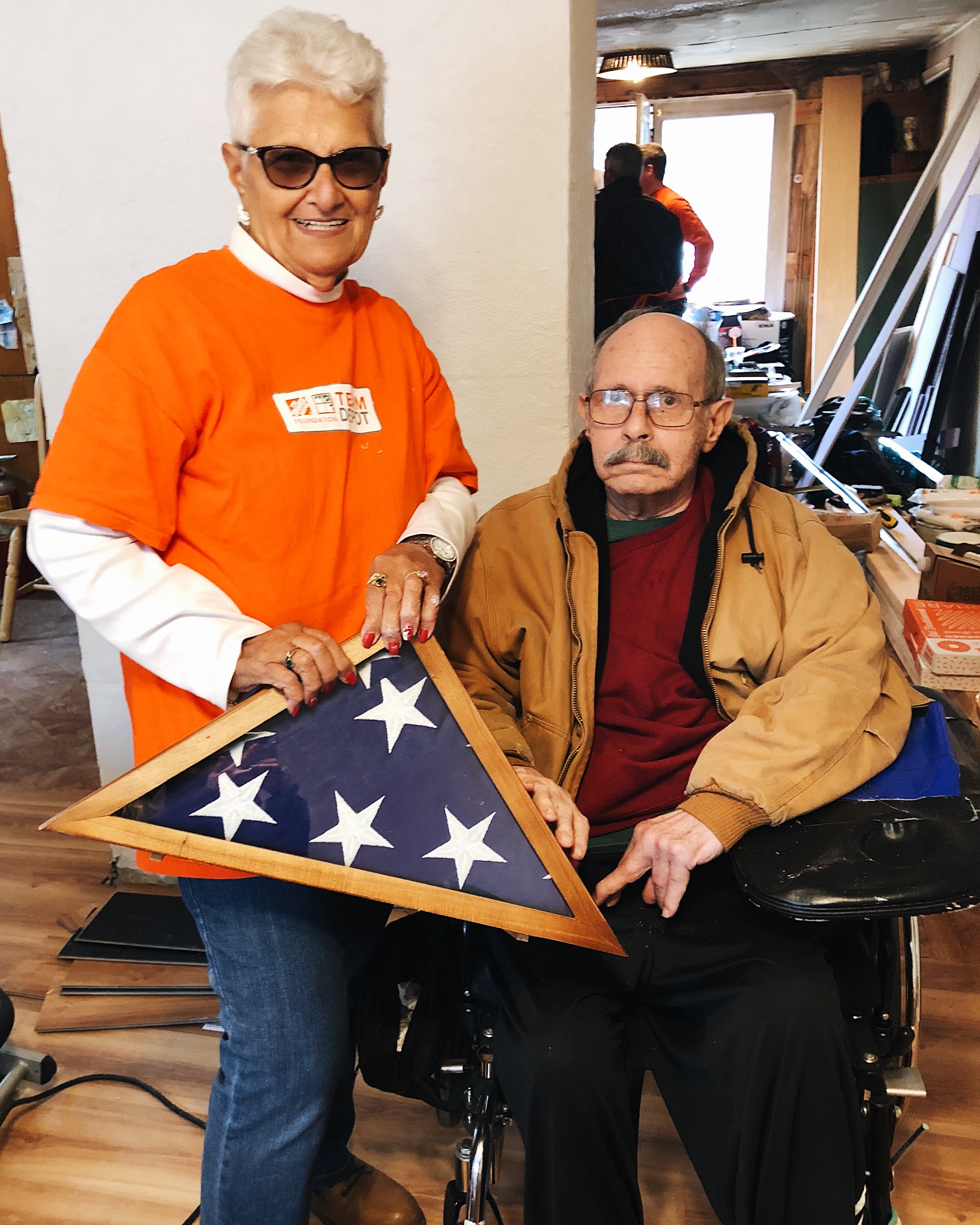 Team Depot volunteer gives flag to veteran 