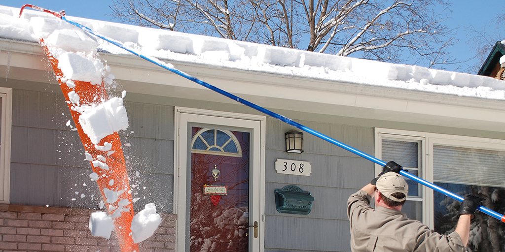 Roof rake clearing snow