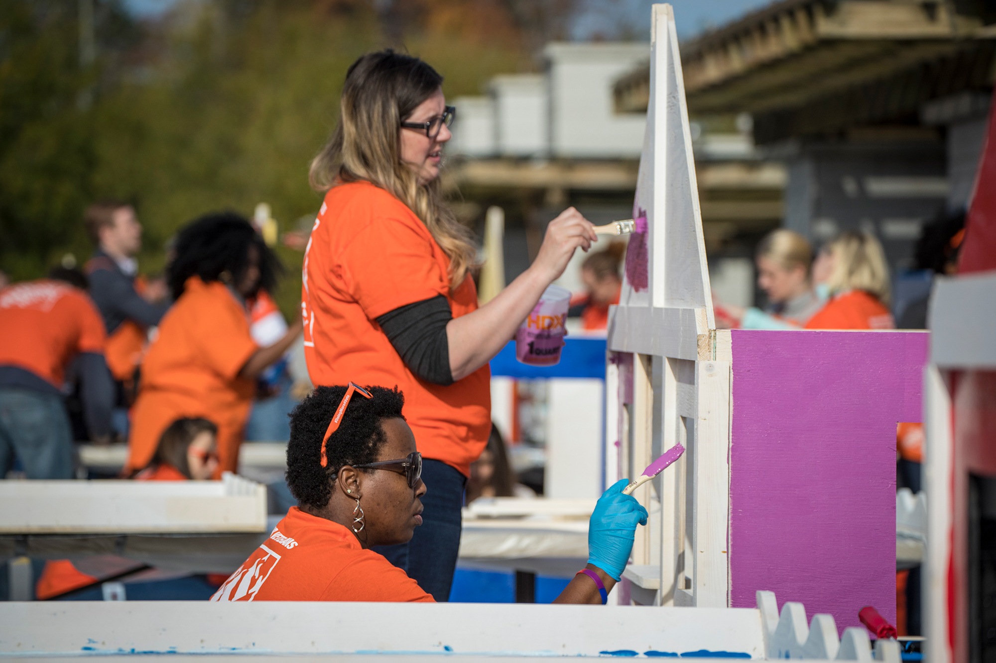 Team Depot volunteer painting playhouse