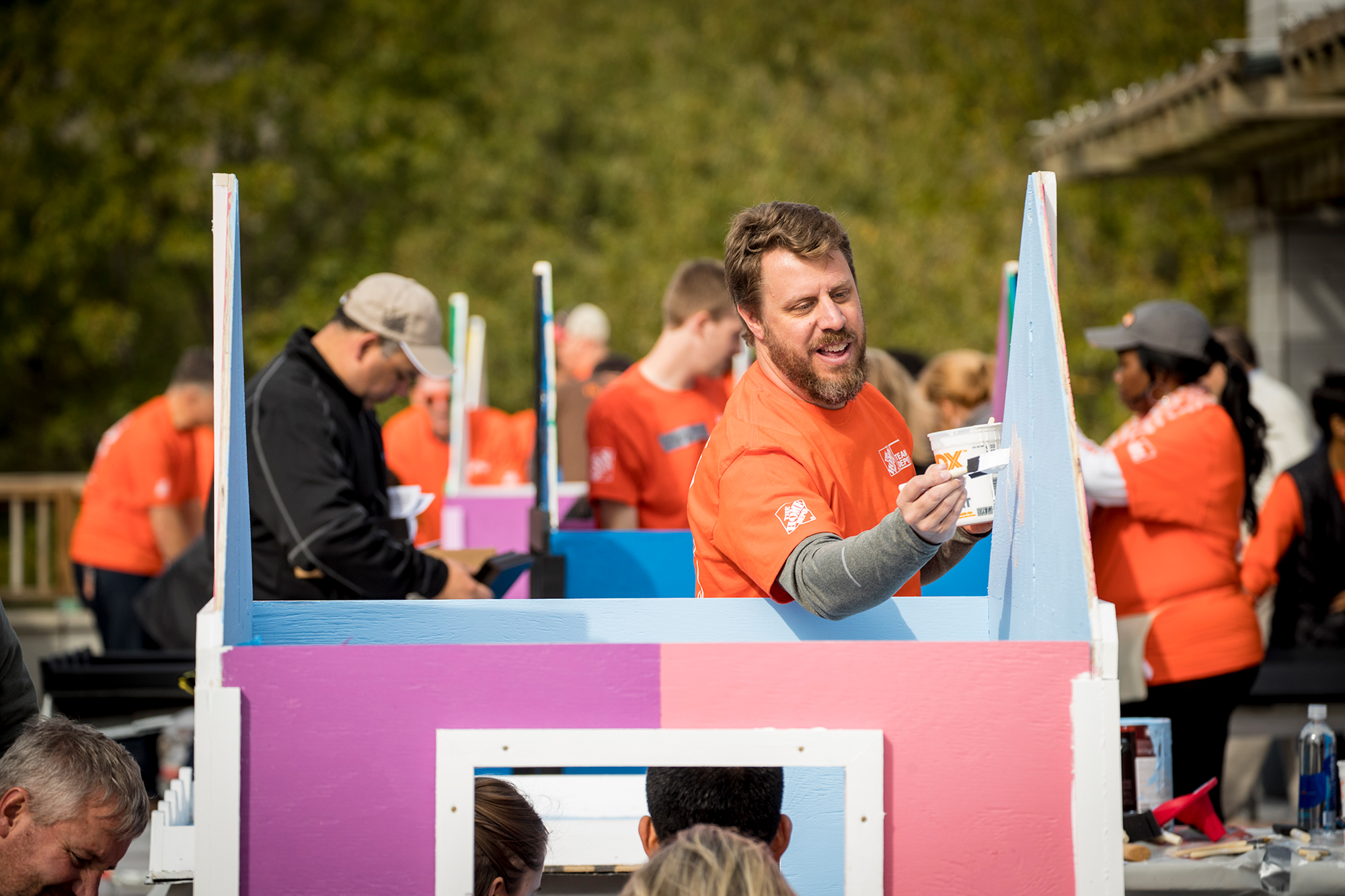 Team Depot volunteer painting playhouse