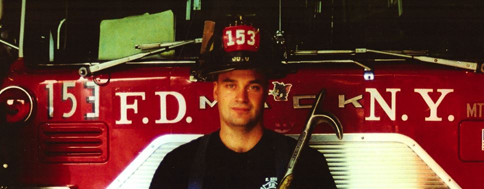 Stephen Siller in fire fighting gear in front of fire truck