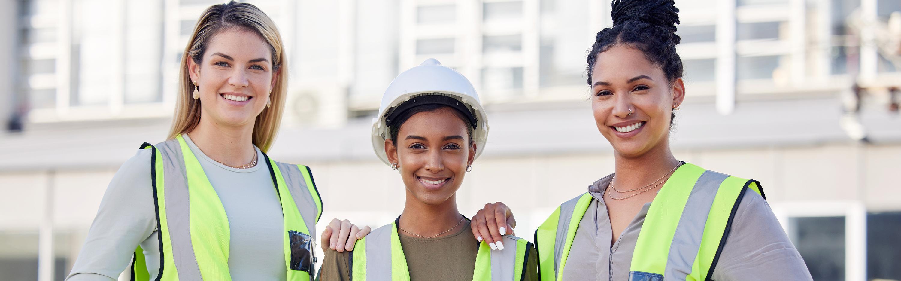 Three women in construction vests