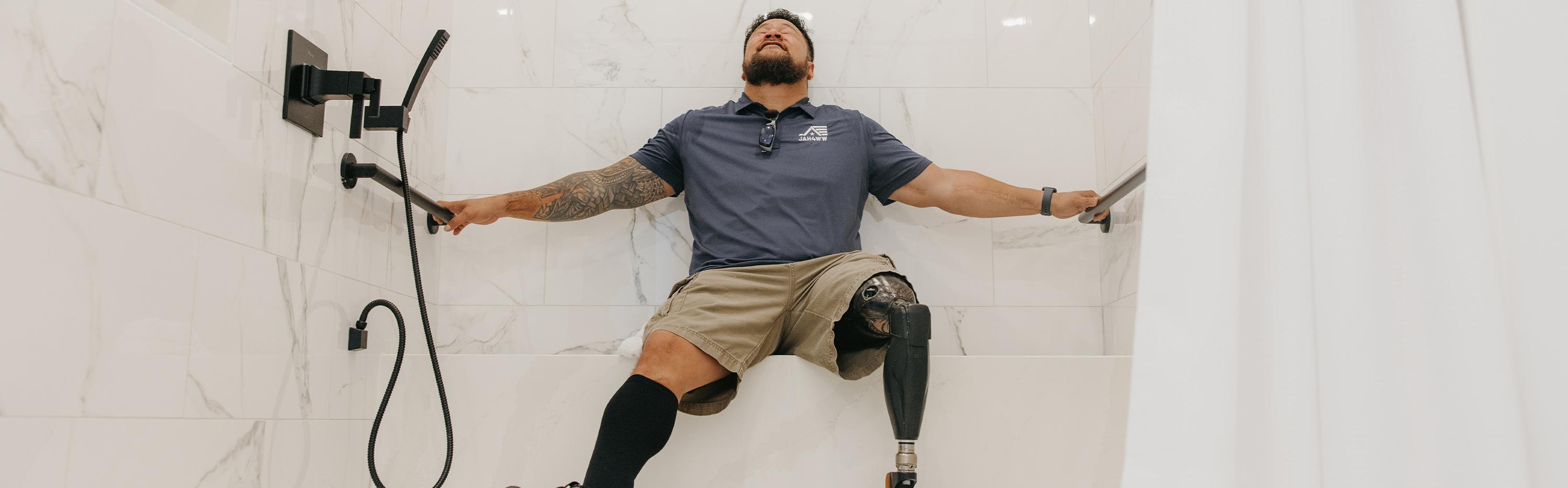 Army veteran reaching for grab bars in a bathroom shower