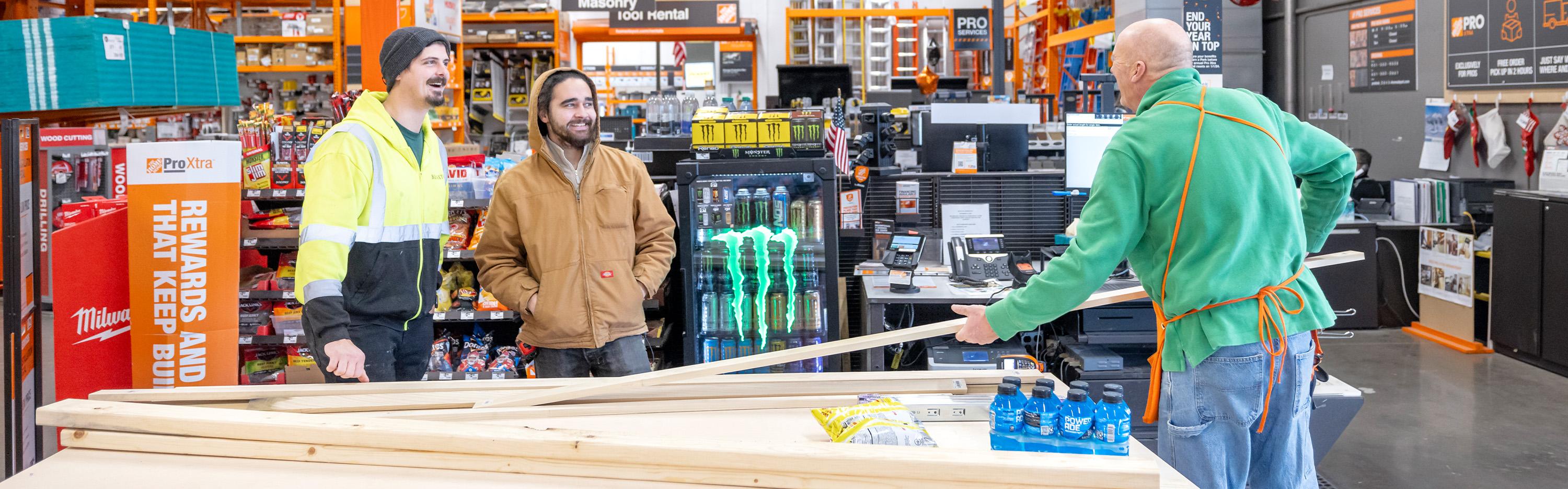 The Home Depot Associate Helping customers in the lumber aisle