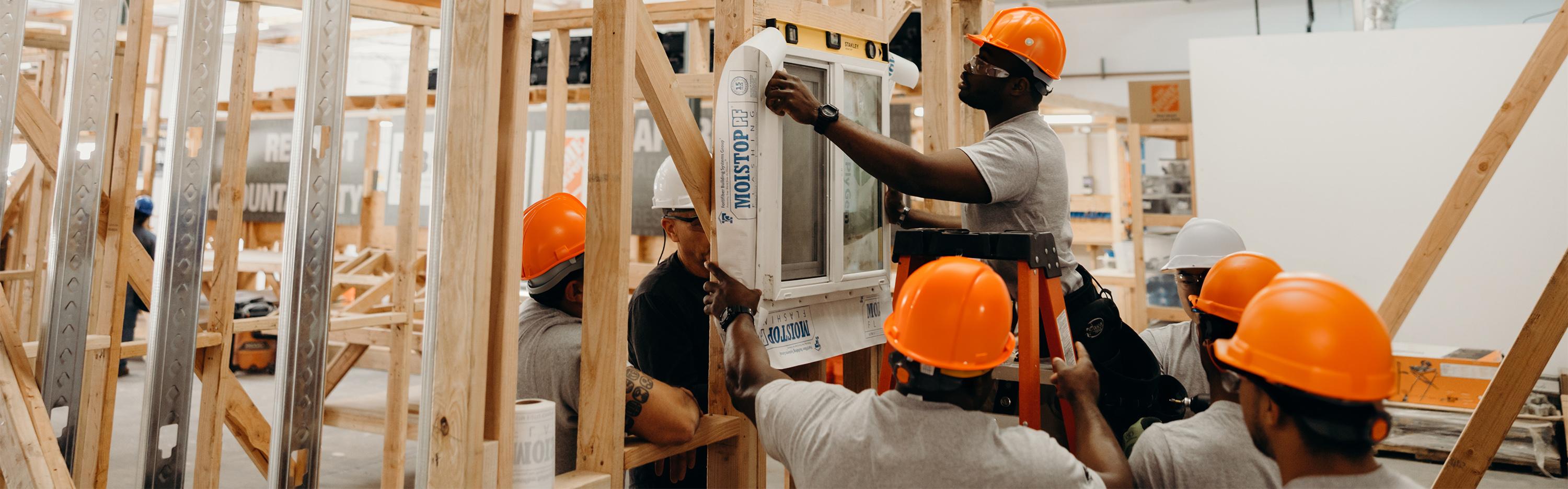 Skilled tradesman training a group of trainees