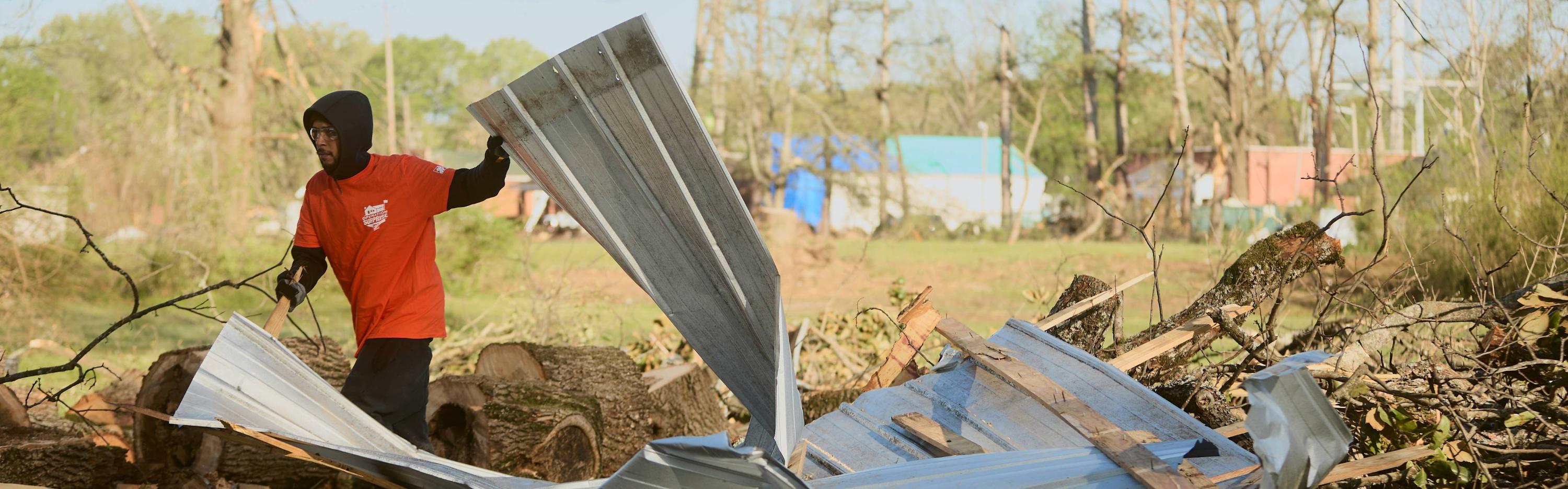 A team depot volunteer cleaning up after a disaster