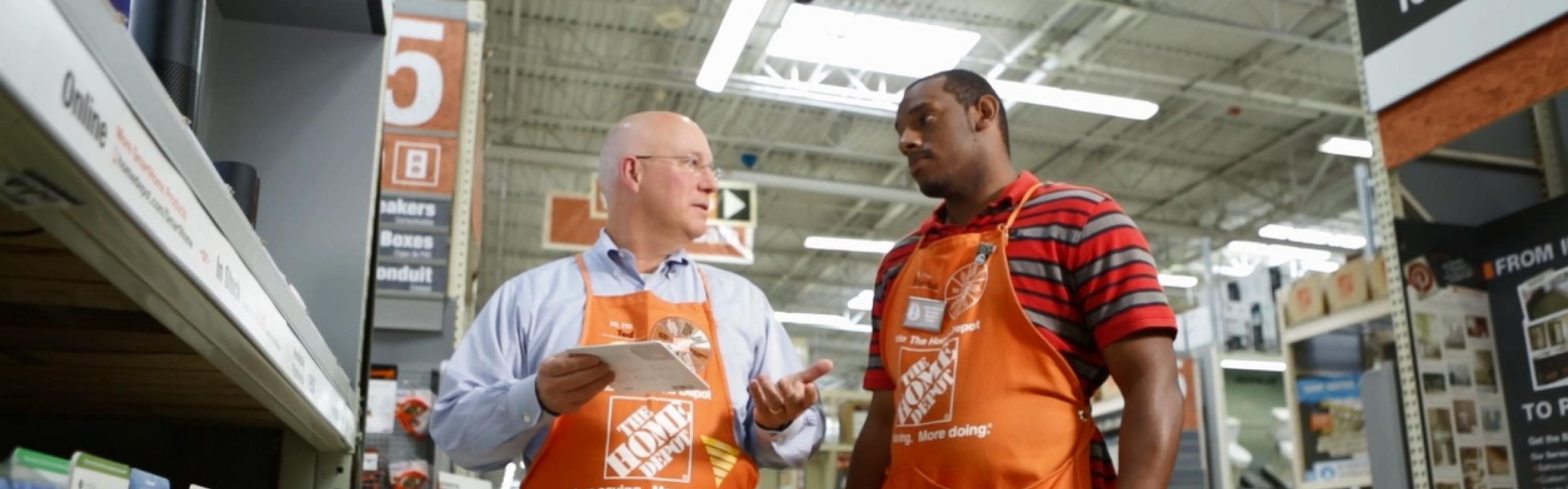 Home Depot's Ted Decker speaks with another associate inside a store