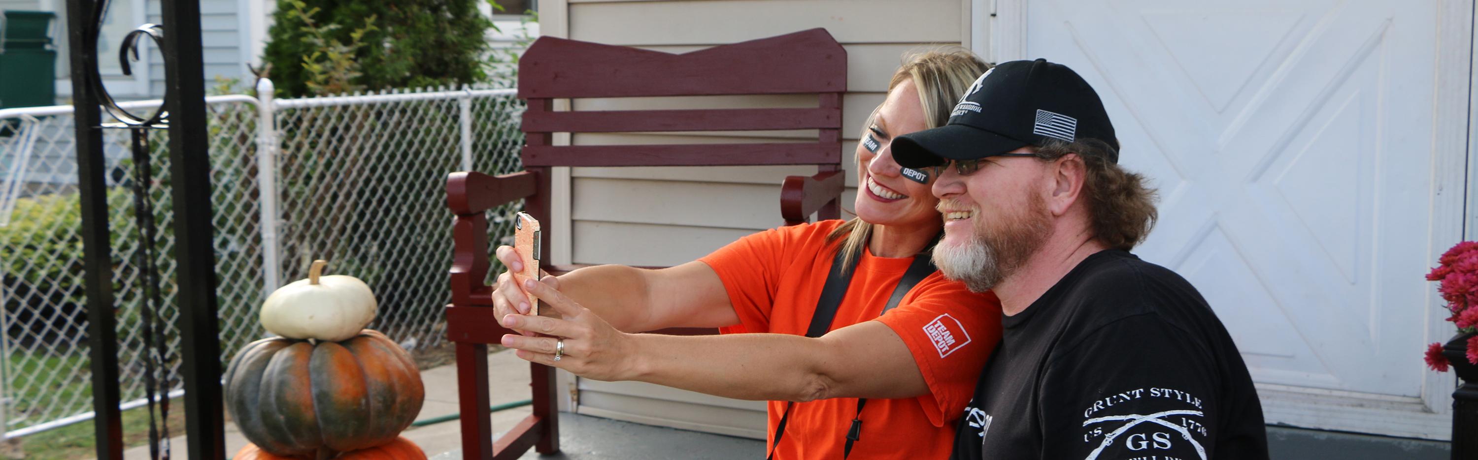 Team Depot volunteer takes a service selfie with veteran