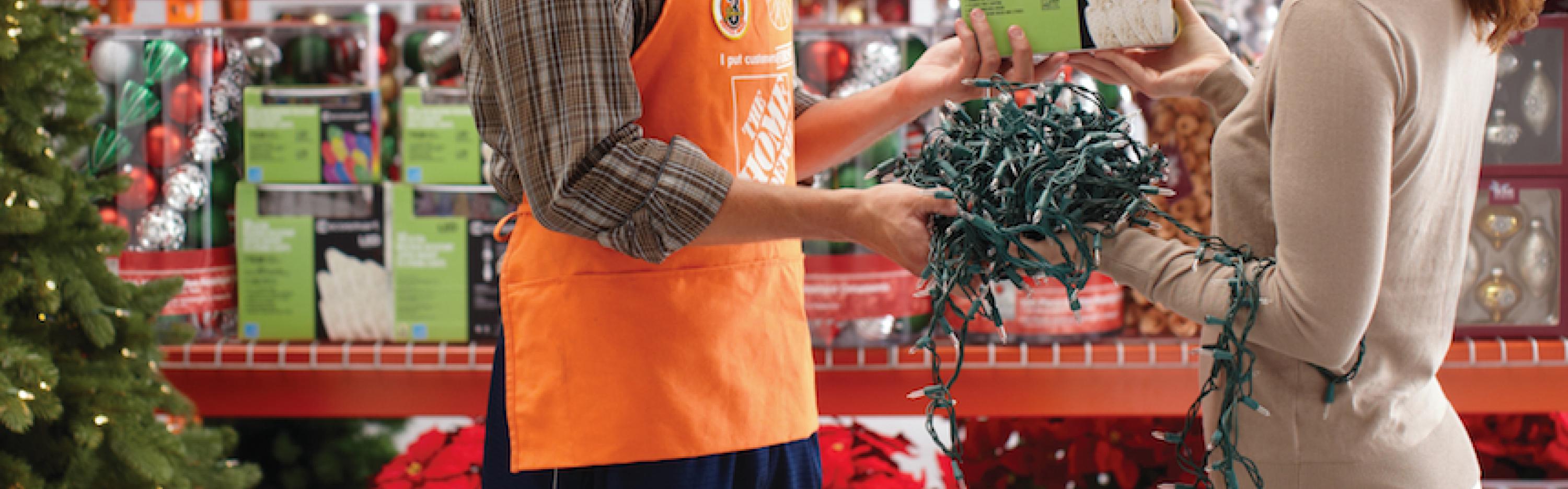 Customer trading holiday lights with Home Depot associate