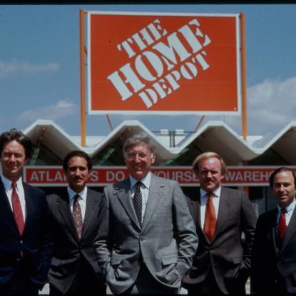 Bernie and Arthur with others standing in front of the first Home Depot store