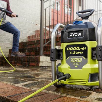 A pressure washer with a man in the background