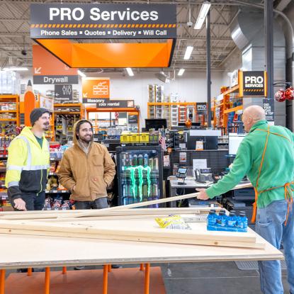 The Home Depot Associate Helping customers in the lumber aisle