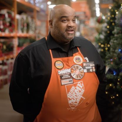 An associate in an orange apron