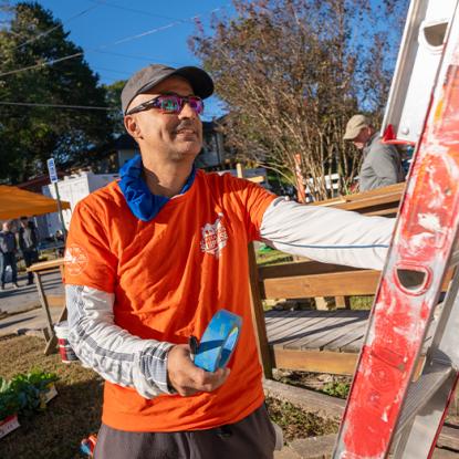 a team depot volunteer securing a ladder