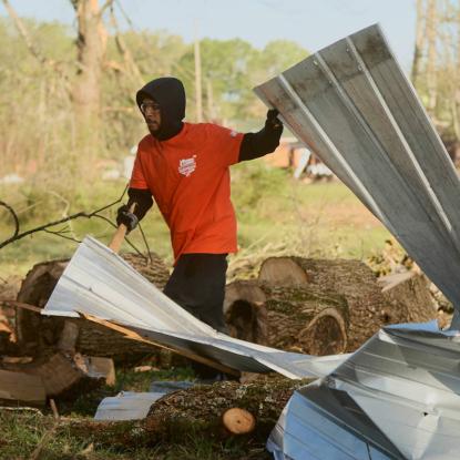 A team depot volunteer cleaning up after a disaster