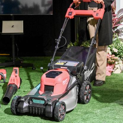 an image of someone pushing a lawn mower