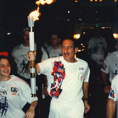 Home Depot co-founder Arthur Blank carries torch at 1996 Centennial Olympic Games. 