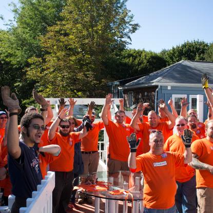 Team Depot volunteers with hands in the air