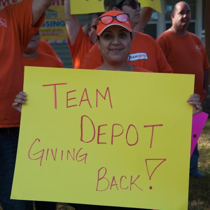 Team Depot volunteer holding sign