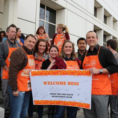 Welcome Desi sign held by associates