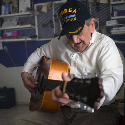 Veteran playing guitar