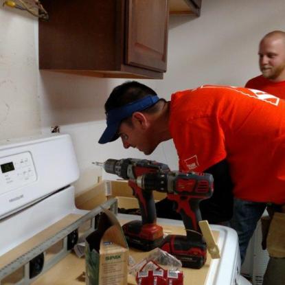 Team Depot volunteers repairing a veteran's home in partnership with Meals on Wheels