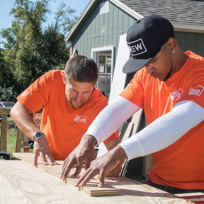 Team Depot volunteers measuring wood cuts