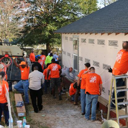 Volunteers work outside Ace's home