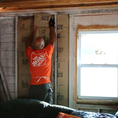 Volunteer hangs insulation