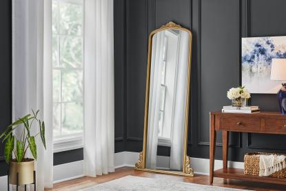 A living room with a decorative mirror and other home decor