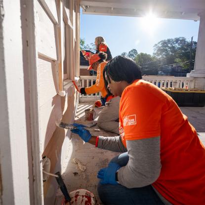 Team Depot volunteers painting a home