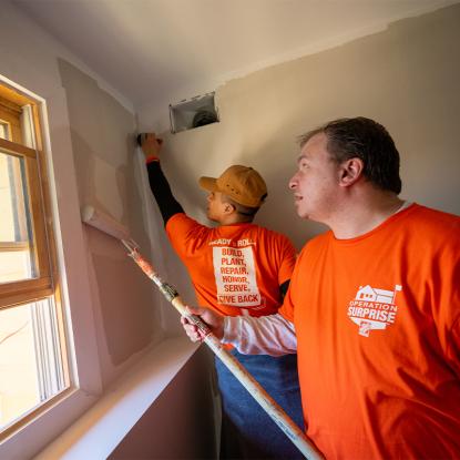 Team Depot volunteers painting a home