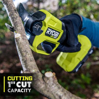 A RYOBI pruner cutting through a tree branch