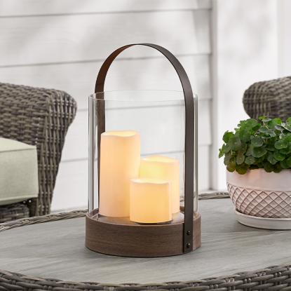 A metal lantern on a patio table