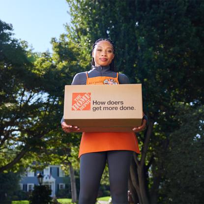Allyson Felix holding a Home Depot box