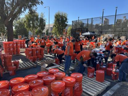 Team Depot Associates filling fire relief buckets at The Home Depot