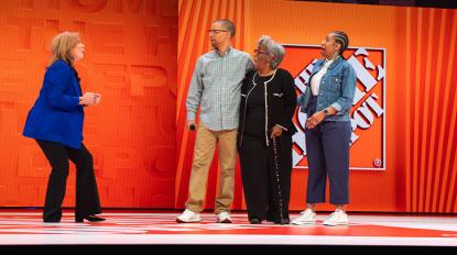 Leonard and family on stage with Crystal Hanlon at The Home Depot's Store Managers' Meeting