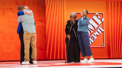 Leonard and family on stage with Crystal Hanlon at The Home Depot's Store Managers' Meeting